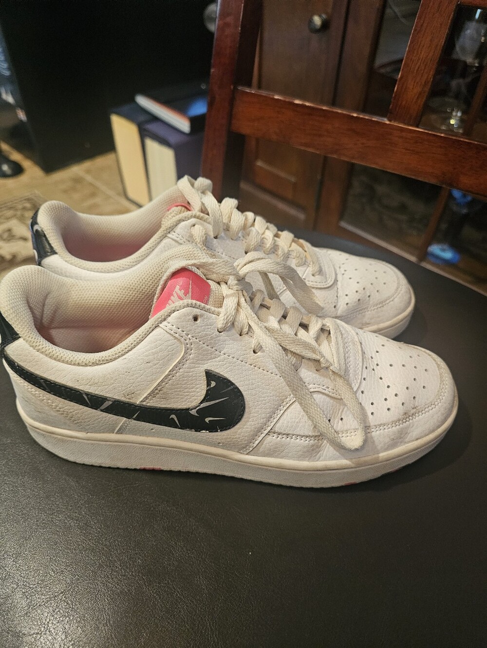 Nike White Low-Top Sneakers with Black Swoosh and Pink Tongue Accent